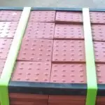 2 green StrapPRO reusable strap system by Lynksols wrapping a pallet | Reusable Straps for Pallets