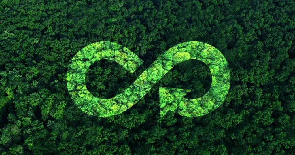 A dense green forest seen from above with a translucent infinity loop symbol featuring arrows, representing the concept of a circular economy and sustainable environmental practices.
